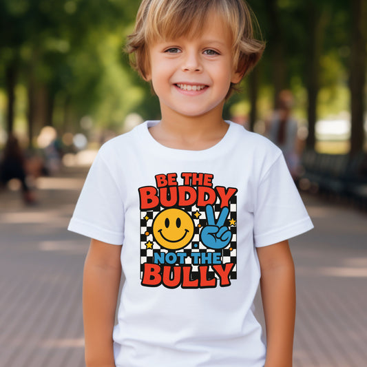 Kid wearing a white with checkered and smiley face that says Be the Buddy Not the bully anti bullying 